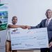 Joshua (L) hands over a dummy cheque to Kamanga