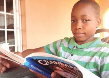 Wakisa enjoys reading while waiting to go to Blantyre Secondary School