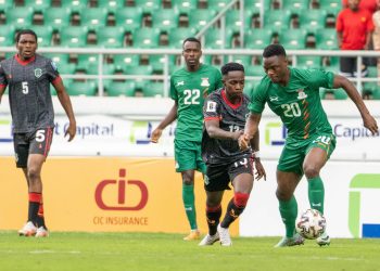 Flames’ Mwaungulu (C) challenges Zambia’s Daka (R) during the match