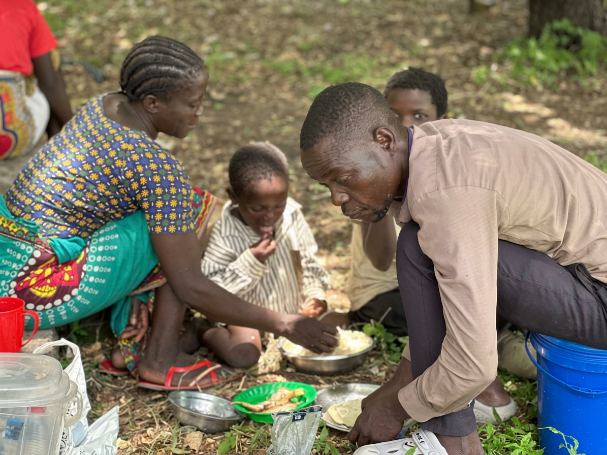 Chimwemwe Julius with his family sharing a meal hunger